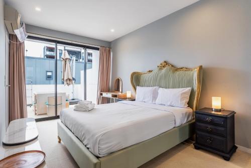a bedroom with a bed and a large window at Westend 3 bedroom Split level Townhouse Next to River in Brisbane
