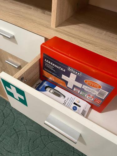 a drawer with a red box in a cabinet at Veľký apartman in Karlova Ves