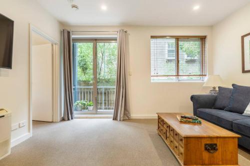 a living room with a couch and a coffee table at Experience the St Kilda Vibe from a Cosy Retreat in Melbourne