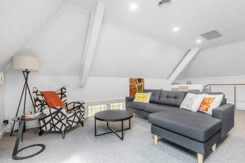 a living room with a couch and a chair at Inner City Living in a Modern Slice of History in Melbourne
