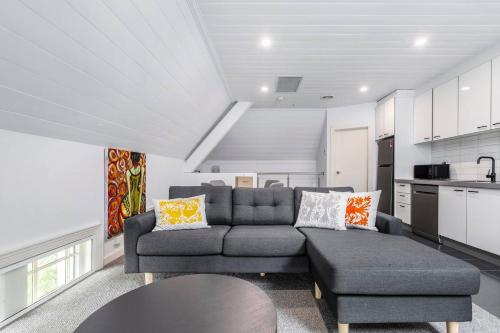 a living room with a couch and a table at Inner City Living in a Modern Slice of History in Melbourne