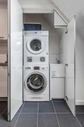 a laundry room with a washer and dryer in it at Inner City Living in a Modern Slice of History in Melbourne