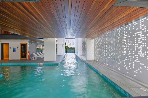 a swimming pool in the middle of a building at Soaring Skyline on Southside at Resort-Style Stay in Brisbane