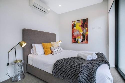 a bedroom with a large bed with pillows at 'Brightly Boutique' A CBD Resort-style Escape in Brisbane