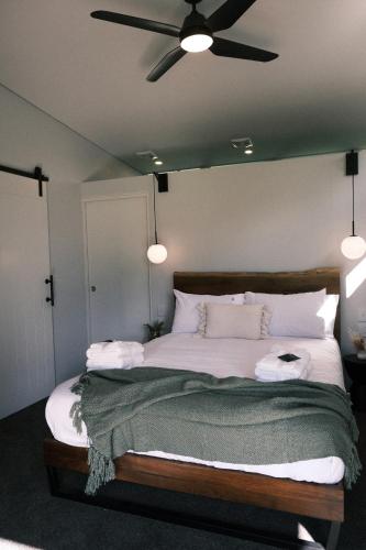 a bedroom with a large bed with a ceiling fan at Buller Wines in Rutherglen