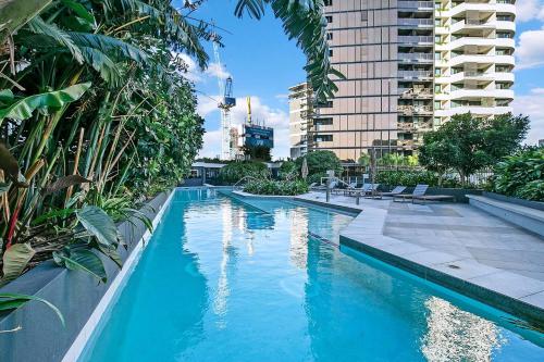 a swimming pool with blue water in a building at The Skyring - Effortless Resort-style Living in Brisbane