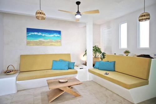 a living room with a couch and a table at 2BdR -Rocks at Mikasa- Near Beach, Pool, King Beds, AC, Fast Wifi in Puerto Escondido