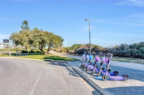a group of people on bikes on the side of a road at Adventure Awaits - Footsteps from West Beach in Adelaide