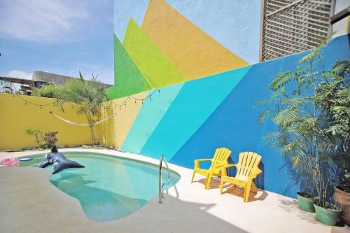 a swimming pool with a dolphin and a chair at 2BdR -Rocks at Mikasa- Near Beach, Pool, King Beds, AC, Fast Wifi in Puerto Escondido