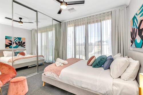 a bedroom with a bed and a large window at 'Brightly Brompton' A Family Delight by the Park in Bowden