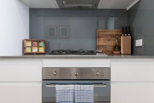 a kitchen with a stove and a counter top at Perfect Prospect Among City's Dining Hotspots in Adelaide