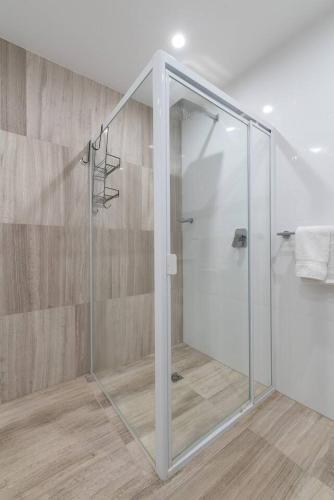 a shower with a glass door in a bathroom at Perfect Prospect Among City's Dining Hotspots in Adelaide