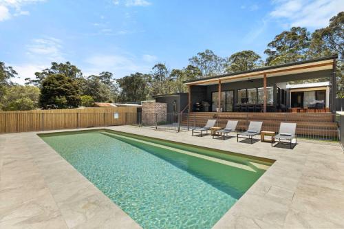 a swimming pool in the backyard of a house at Thalassa Huskisson by Experience Jervis Bay in Huskisson