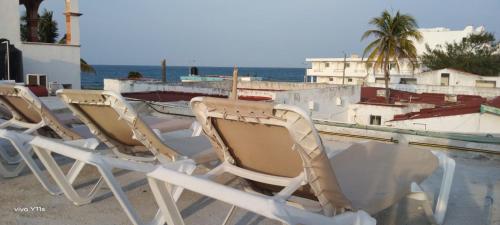 a group of chairs sitting on top of a boat at Casa Aura - Center Studio - 1st Floor in Isla Mujeres