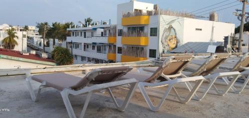 a row of lounge chairs sitting on a roof at Casa Aura - Center Studio - 1st Floor in Isla Mujeres
