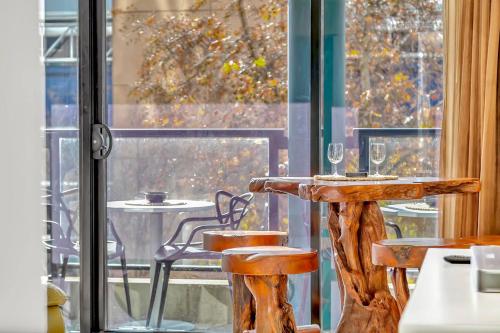 a table and chairs in front of a window at Little Oak Lodge - Wellness is Calling in Adelaide