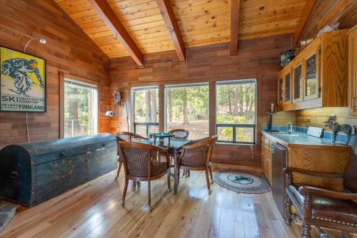 a dining room with a table and chairs in a cabin at Cozy Home with Lake Views Decks Hot-Tub Walk to Private HOA Beach in 5 min in Tahoe City
