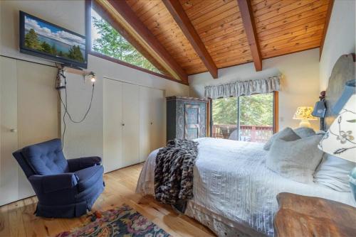 a bedroom with a bed and a chair at Cozy Home with Lake Views Decks Hot-Tub Walk to Private HOA Beach in 5 min in Tahoe City