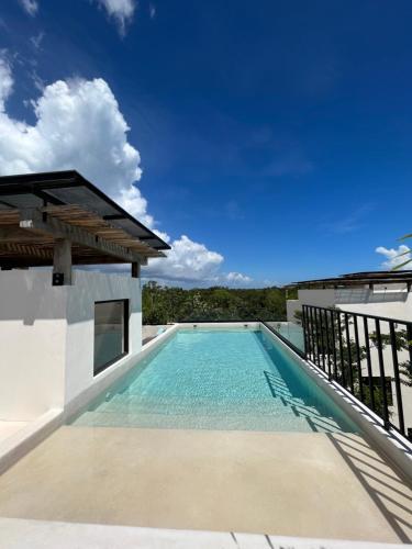 a swimming pool on the roof of a house at Arena Tuane in Tulum