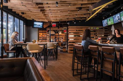 two women sitting at the bar in a restaurant at Delta Hotels by Marriott Waterloo in Waterloo