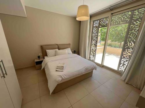 a bedroom with a bed and a large window at One Bedroom - Mangroovy El Gouna in Hurghada