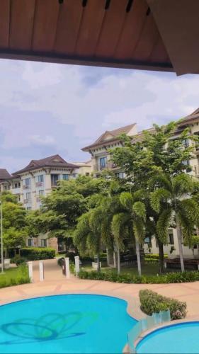 a view of a resort with palm trees and a swimming pool at Davao 2br One Oasis Beside SM Mall-Wifi in Davao City