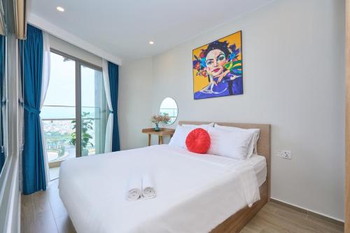 a bedroom with a large white bed and a window at VIP THE SÓNG APARTMENT NEAR THE BEACH 5 STAR - FREE INFINITy in Vung Tau
