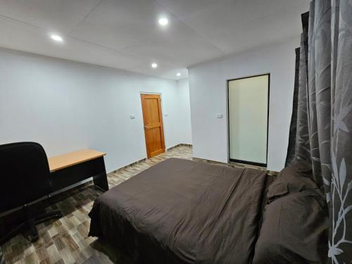 a bedroom with a bed and a desk and a desk at Blissful Calm in Nadi