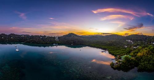 an aerial view of a lake at sunset at Edgewater Dive & Spa Resort in Puerto Galera