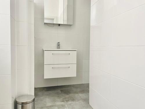 a white bathroom with a sink and a toilet at 100 m2 Apartment - Free Parking- 15 min to Center in Vienna