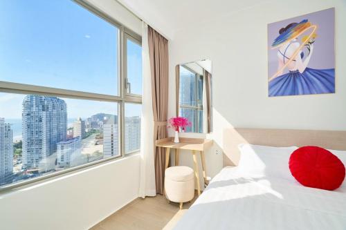 a bedroom with a bed and a large window at VIP THE SÓNG APARTMENT NEAR THE BEACH 5 STAR - FREE INFINITy in Vung Tau