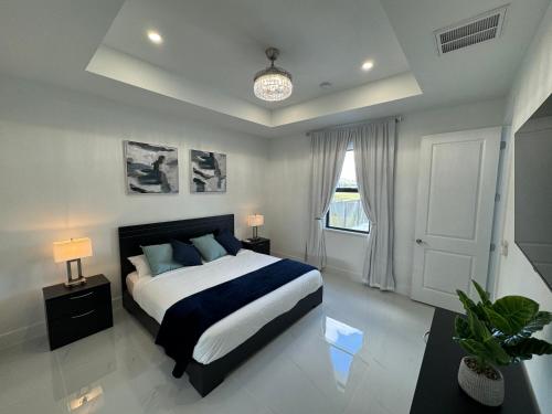a bedroom with a large bed and a window at Dream Family Home Vacation in Cape Coral