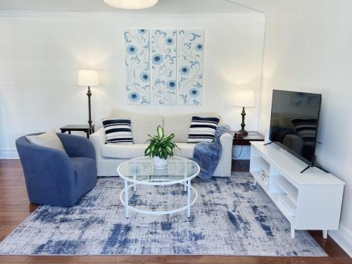 a living room with a couch and a table at Modern 1BR apt in the heart of downtown Wilmington in Wilmington