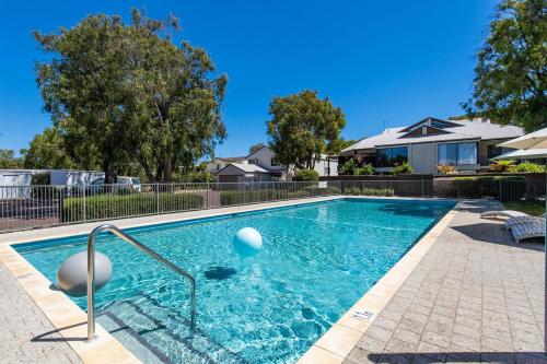 a swimming pool with a ball in the water at Escape to 67 at Cape View in Broadwater