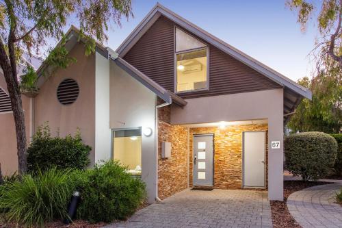a house with a brick facade and a driveway at Escape to 67 at Cape View in Broadwater