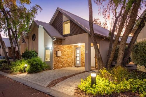 a house with a stone driveway in front of it at Escape to 67 at Cape View in Broadwater