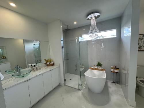 a bathroom with a tub and a shower and a sink at Dream Family Home Vacation in Cape Coral