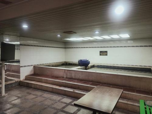 a waiting room with stairs and a blue bowl on the wall at Horison Ultima Bandung in Bandung