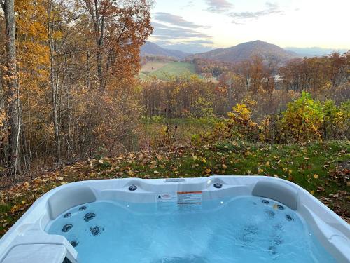 a jacuzzi tub sitting on top of a hill at Blue Sky Cabin - Built in 2023 this 3 bed 2,5 bath home has gorgeous views in Jefferson