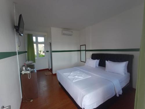 Postel nebo postele na pokoji v ubytování Hotel Ompu Herti