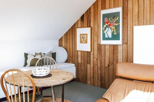 a living room with a table and a couch at The Barn - Georges Bay, St Helens in St Helens