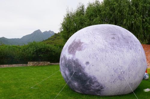a large purple ball sitting on the grass at Brickyard Retreat at Mutianyu Great Wall Adjoin to Mutianyu Great Wall - Room with the View of Great Wall - Chinese massage experience - Vehicle Shuttle Service - International Catering - SPA& Nail Beauty Facilities in Huairou