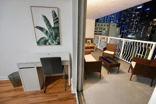 a balcony with a table and chairs on a building at City & Sea View+FREE Parking Modern Condo in Miami