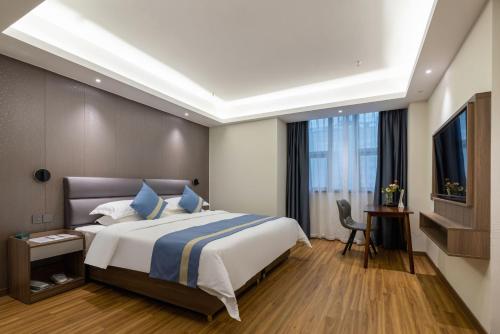 a hotel room with a bed and a television at Citadines Zhengda Mall Hefei in Hefei
