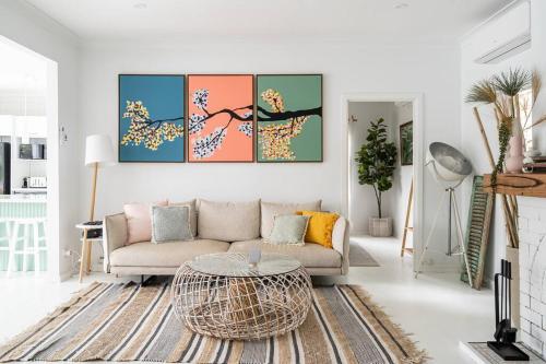 a living room with a couch and a table at rivescape holiday home at Berowra Waters in Berrilee
