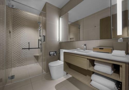 a bathroom with a sink and a toilet and a shower at Hyatt Place Johor Bahru Paradigm Mall in Johor Bahru