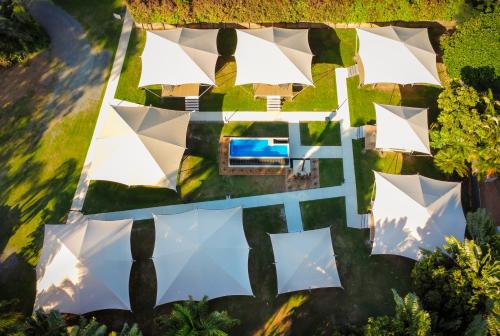 an aerial view of a house with white umbrellas at Poinciana at Cooee Bay in Yeppoon
