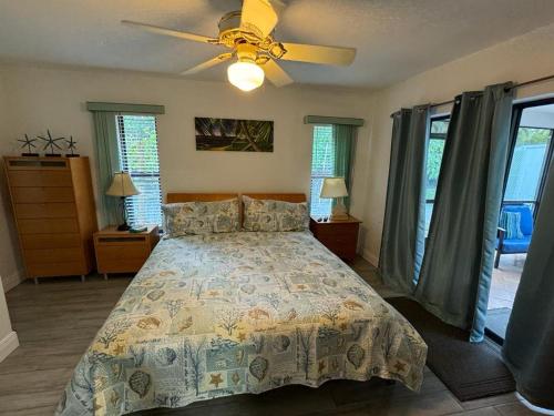 a bedroom with a bed and a ceiling fan at Bonita Oasis in Bonita Springs