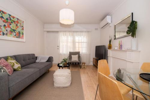 a living room with a couch and a tv at Cranbrook Courtyard - A Sunny City-fringe Retreat in Adelaide