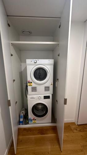 a washer and dryer in a small room at Nest Apartments on Rose Lane in Melbourne